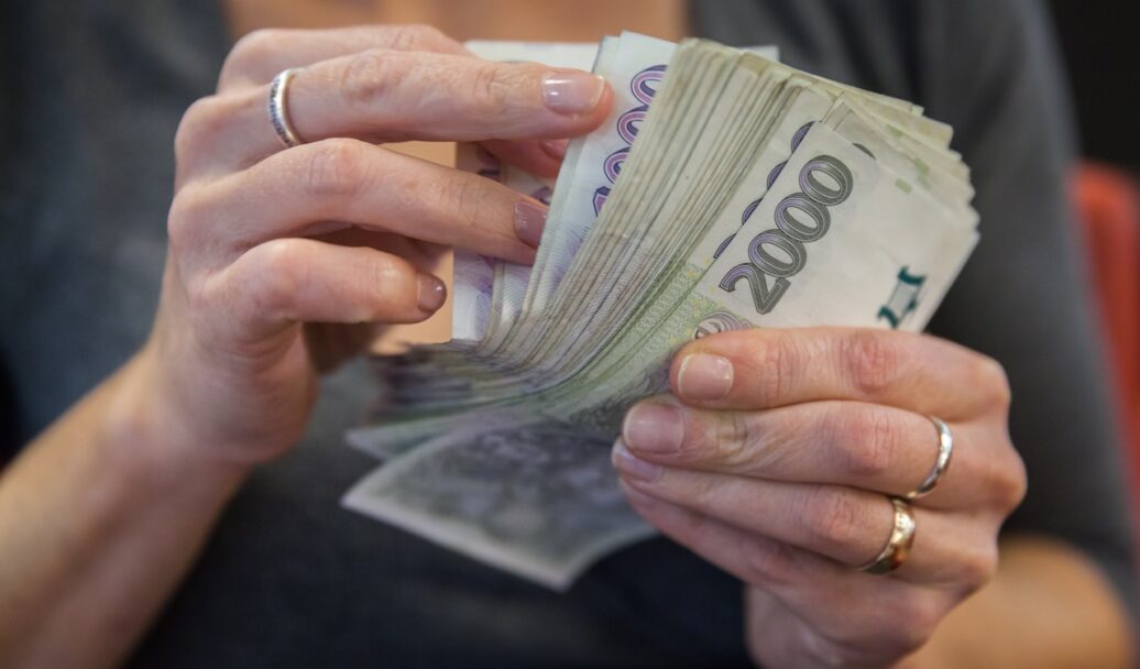counting Czech banknotes in a bank during a transaction