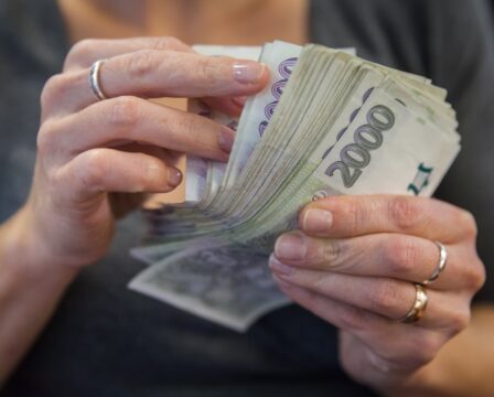 counting Czech banknotes in a bank during a transaction